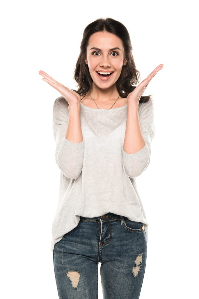 attractive excited woman standing in casual clothes, isolated on white